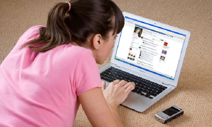 Young woman looking at Facebook