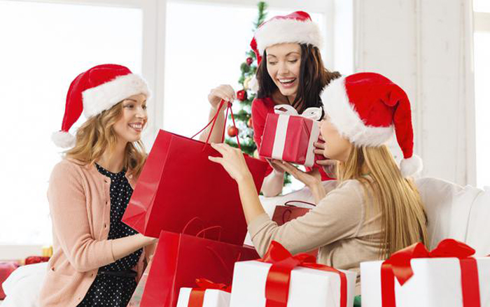 women in santa helper hats with shopping bags