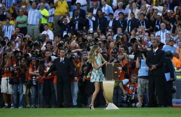 Supermodel Gisele Bundchen opens the box containing the 2014 World Cup trophy before the start of the final match between Germany and Argentina at the Maracana stadium in Rio de Janeiro