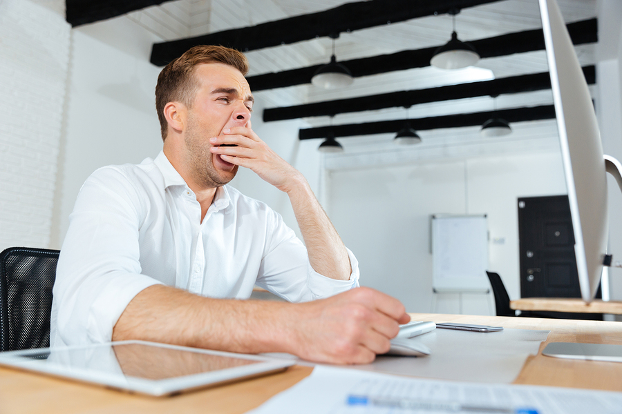 bigstock Sleepy tired young businessman 139717727